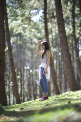 Young woman standing in forest looking ahead