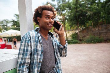 Cheerful african man talking on cell phone