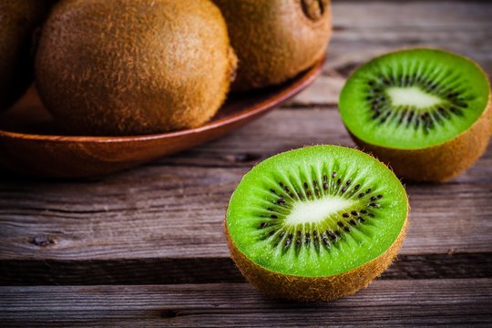 organic fresh juicy kiwi on dark wooden background