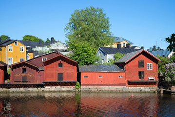Naklejka na ściany i meble Town embankment with ancient port warehouses on the sunny June day. Porvoo, Finland