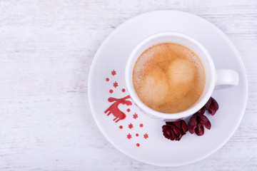 Christmas cup of espresso coffee on white wooden background, top view