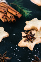 Fototapeta na wymiar Star shaped cookies with cinnamon and anise on the table