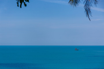 The boat in the azure ocean