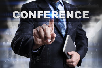 Businessman is pressing button on touch screen interface and selecting conference.