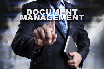 Businessman is pressing button on touch screen interface and selecting document management.