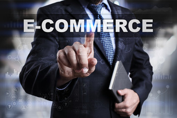 Businessman is pressing button on touch screen interface and selecting e-commerce.