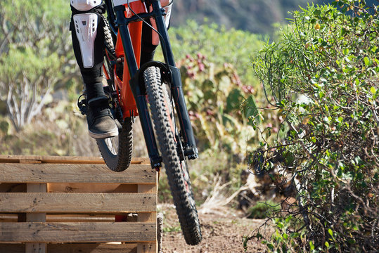 Downhill mountain bike,jump on the artificial ramp