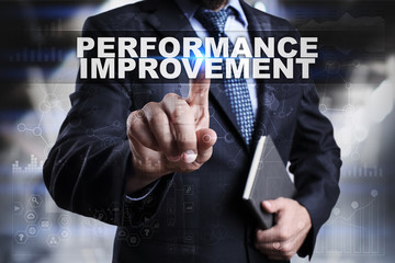 Businessman is pressing button on touch screen interface and selecting performance improvement.