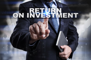 Businessman is pressing button on touch screen interface and selecting return on investment.