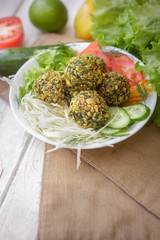 Delicious falafel salad. Salad include tomatoes, cucmbers and falafel.