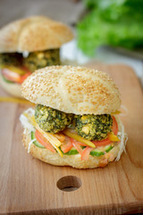 Vegetarian fast food - falafel burger on wooden board.