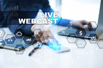 Businessman is working in office, pressing button on virtual screen and selecting live webcast