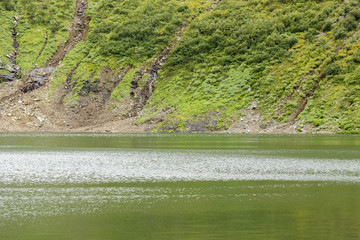 Russia. Khakassia. Sayan Mountains. Reserve Kuznetsky Alatau. Icy mountain lake, originating water from Snowfield.