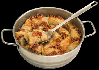 Cabbage Rolls Stuffed With Minced Meat Cooked In Tomato Sauce With Smoked Pork Ham Slices Served In Stainless Steel Saucepot Isolated On Black Background