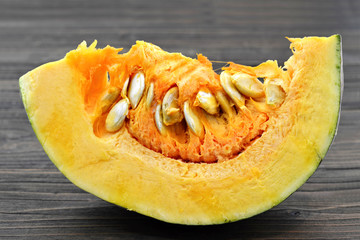 Pumpkin slice on wooden background