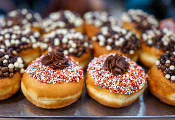 Close up of fresh donuts on bakery display for Hanukkah  celebration. Selective focus.