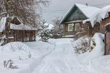 Snowy street in winter village. Early winter this year in the village.