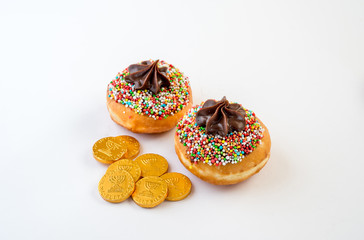 Fresh donuts  and chocolate coins for Hanukkah celebration. Selective focus.