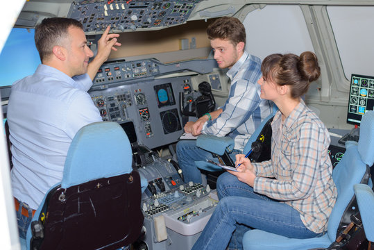 Young people visiting an aircraft simulator