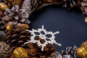 Christmas wreath of cones and toys made of wool