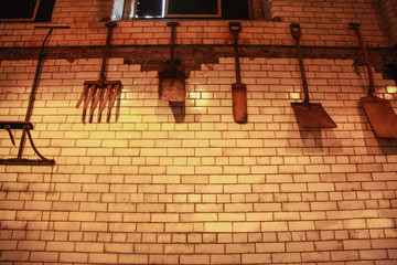 malt forks and shovels hanging on a tiled wall.JPG