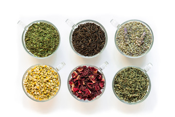 Six cups with different tea leaves isolated on white background.