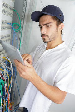 focused electrician applying safety procedure while working on electrical panel