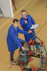 Men working with copper pipe, looking up