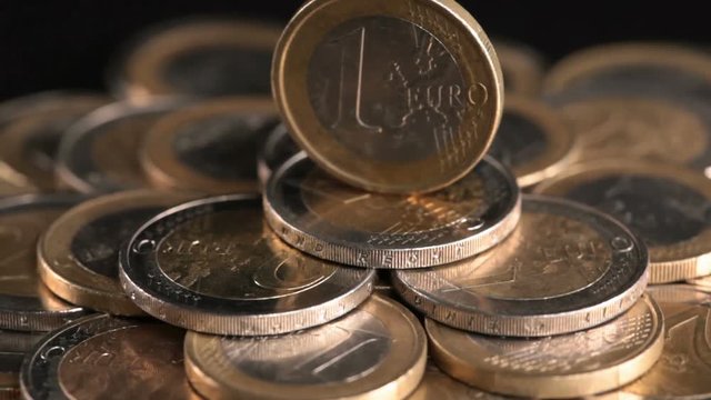 Euro coin on money pedestal - financial power concept, closeup dolly shot