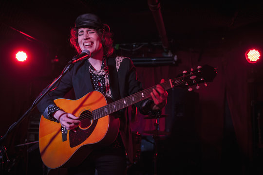 Female guitarist performing in nightclub