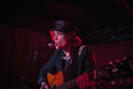 Female guitarist performing in nightclub