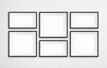 Collage of black wooden frames on bricks wall, interior decor mock up