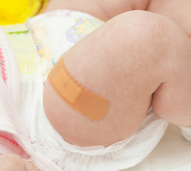 Leg of a newborn with the patch after vaccination.