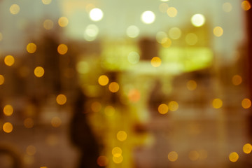 the reflection in the window of the Christmas lights and people as a background, substrate, and bright
