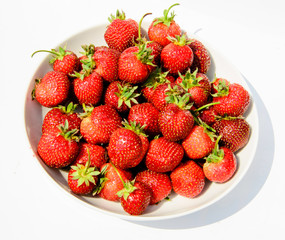 delicious, so sweet and juicy strawberries on a white plate