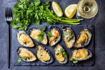 Seafood. Baked mussels with cheese and lemon in shells