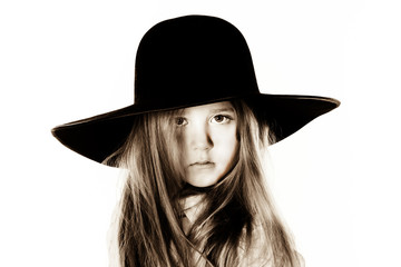 LIttle girl posing like a model in mother's hat