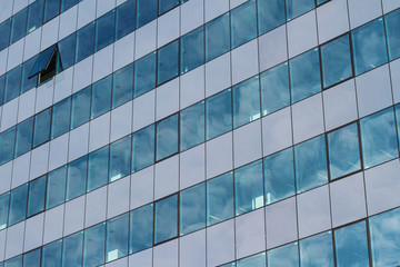 office building with many glass windows and one open