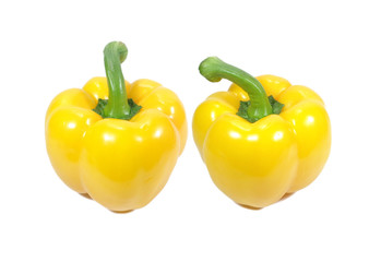 Two ripe vivid yellow bell peppers with green stem isolated on white background, Close-up 