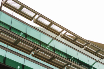Detail of an office building with glass windows and exterior cur