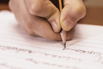 School Boy Writing Close Up. Pencil in Children Hand. - 127437485