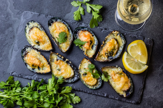 Seafood. Baked mussels with cheese and lemon in shells