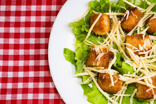 Caesar Salad With Croutons On A White Plate