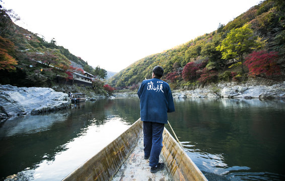 Man driving boat, Hozugawa River, Arashiyama, Kyoto, Japan, East Asia 
