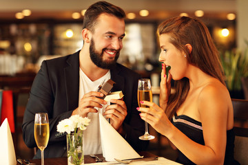 Young man proposing to beautiful woman