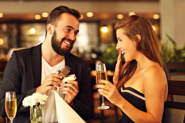 Young man proposing to beautiful woman