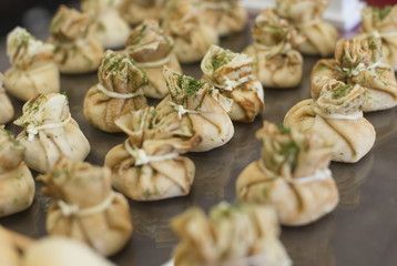 Fototapeta premium Stuffed pancake bags on a buffet table.