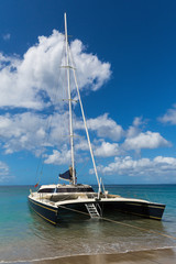 Catamaran just off the beach on St Nevis near St Kitts in the Caribbean
