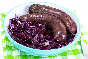 Blood sausage with garnish on old wooden table