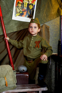 6 years old boy in the Russian military form, beautiful with blue eyes.